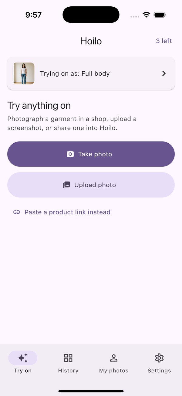 The Hoilo try-on screen on an iPhone, showing the active photo of the user and buttons to take a photo, upload one, or paste a product link.